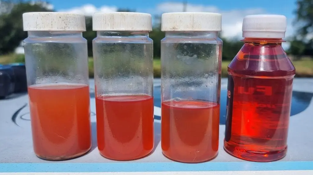 Fuel Storage 2 a group of plastic bottles with red liquid in them