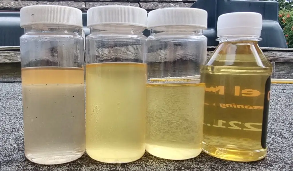 Fuel Storage 3 a group of plastic bottles with yellow liquid in them